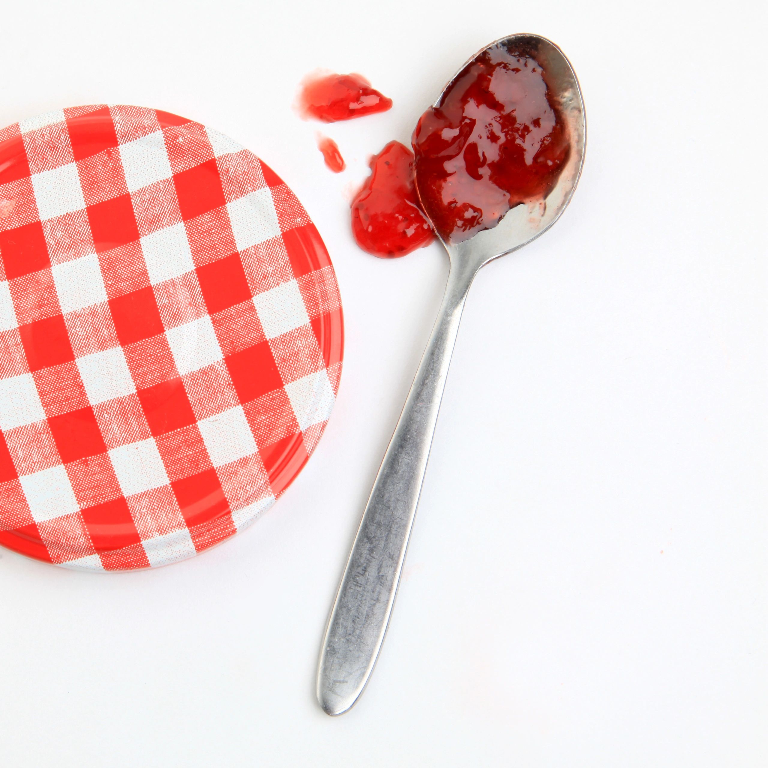 Small-batch jam jar styled on a rustic kitchen surface